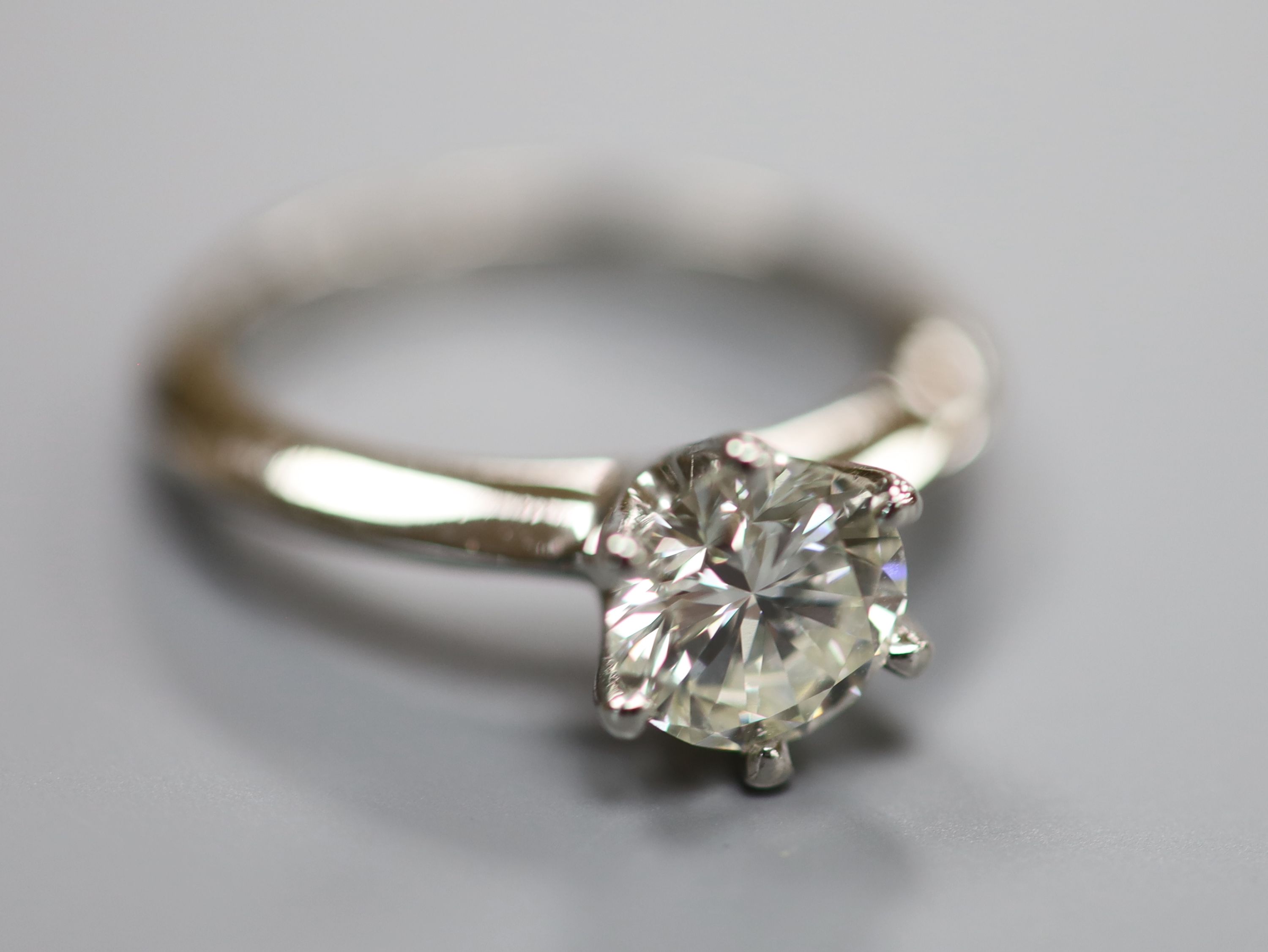 A modern platinum and solitaire diamond ring,